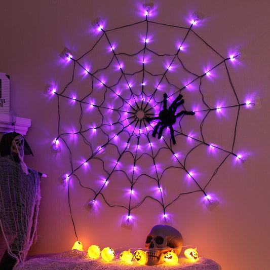 Halloween-themed spider web with purple lights and a skeleton in a room.