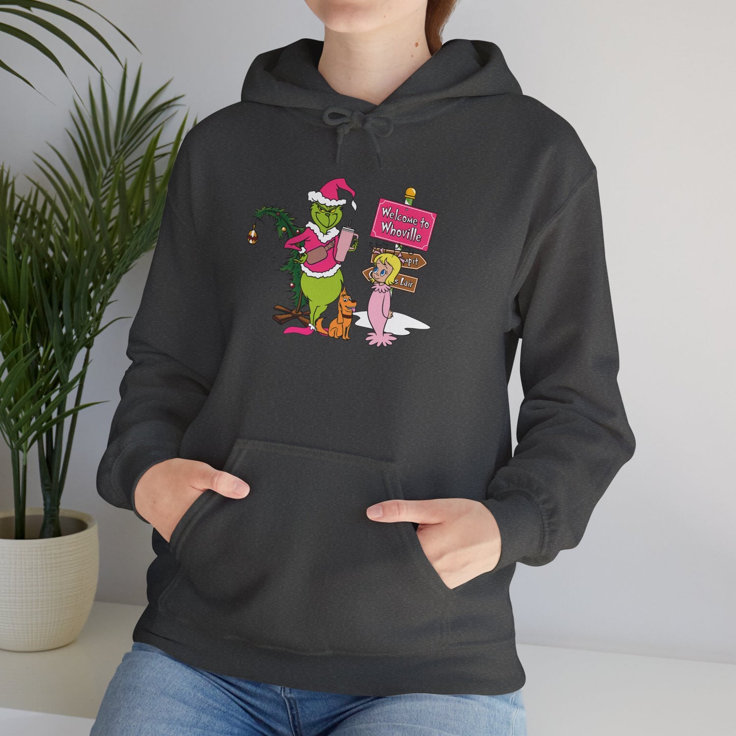 Welcome to Merryville Christmas Hoodie – Cute Green Creature & Winter Village Sweatshirt (Unisex)