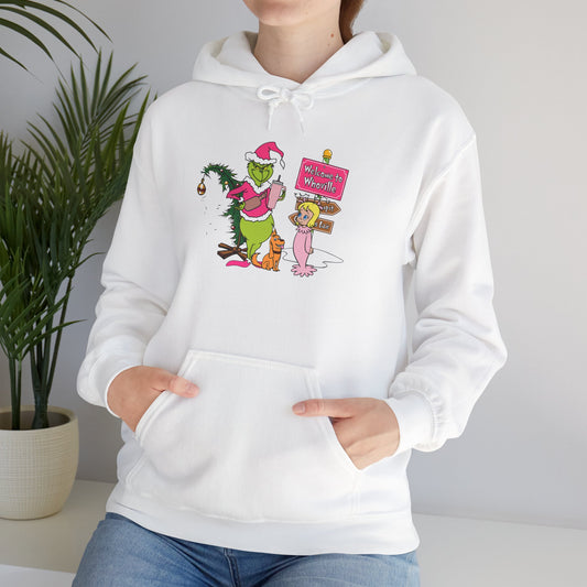 Welcome to Merryville Christmas Hoodie – Cute Green Creature & Winter Village Sweatshirt (Unisex)