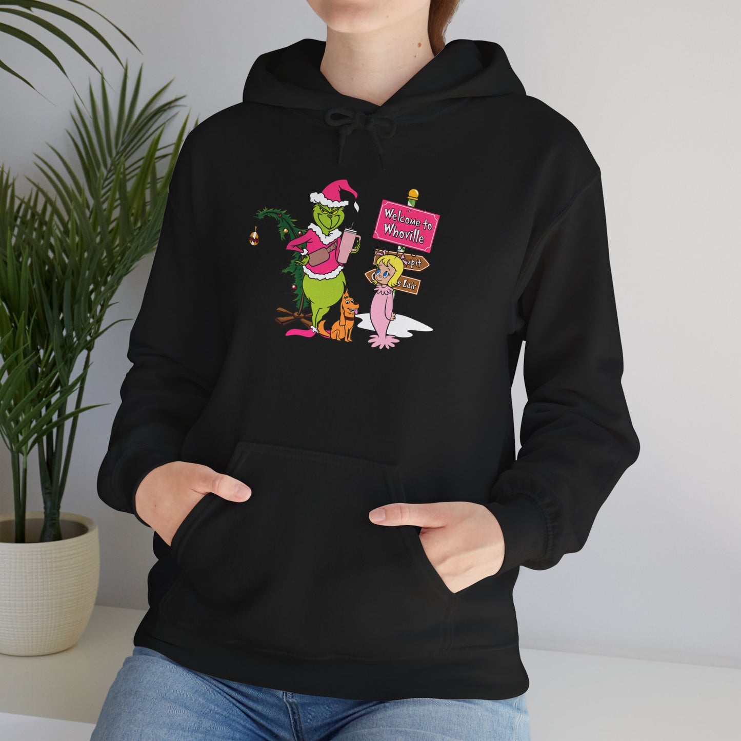Welcome to Merryville Christmas Hoodie – Cute Green Creature & Winter Village Sweatshirt (Unisex)