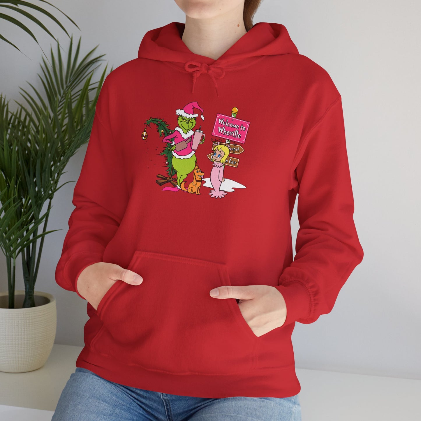Welcome to Merryville Christmas Hoodie – Cute Green Creature & Winter Village Sweatshirt (Unisex)