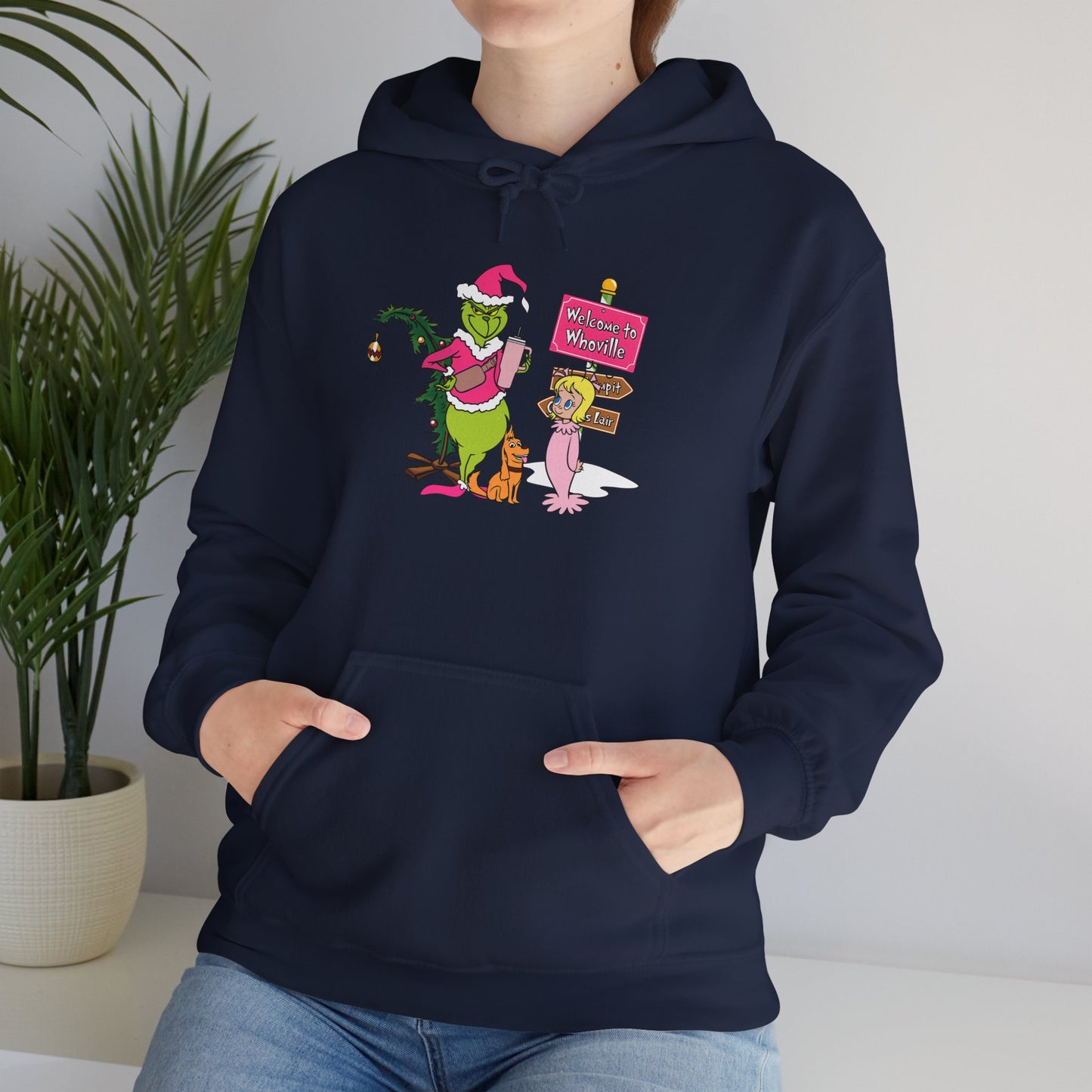 Welcome to Merryville Christmas Hoodie – Cute Green Creature & Winter Village Sweatshirt (Unisex)