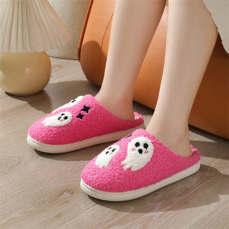 Pink slippers with dog designs worn indoors on a wooden floor.